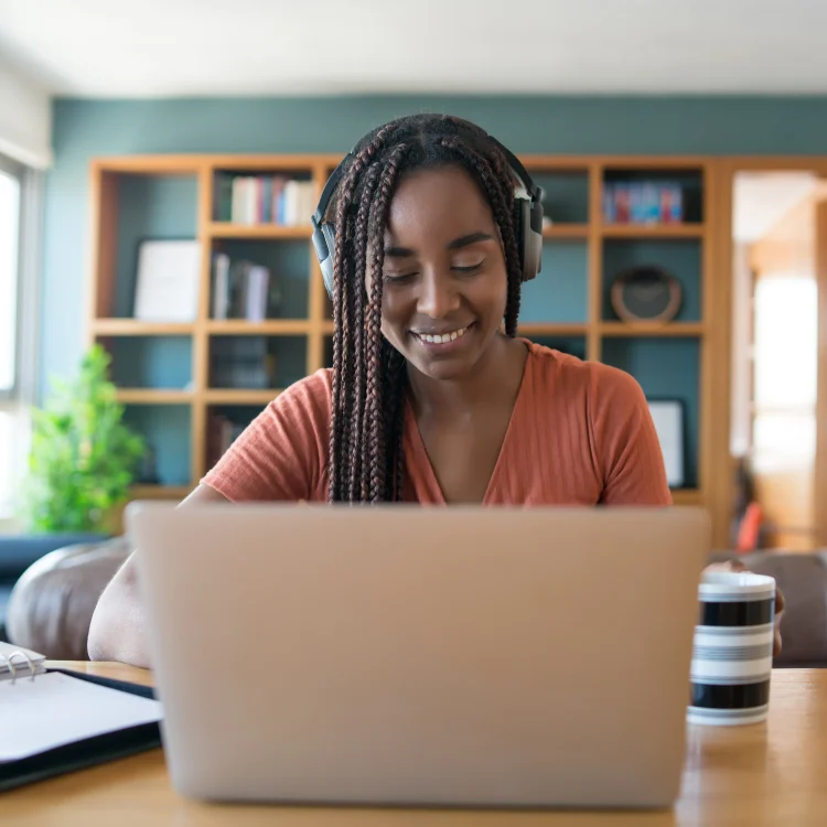 portrait-woman-video-call-with-laptop-headphones-while-working-from-home-concept
